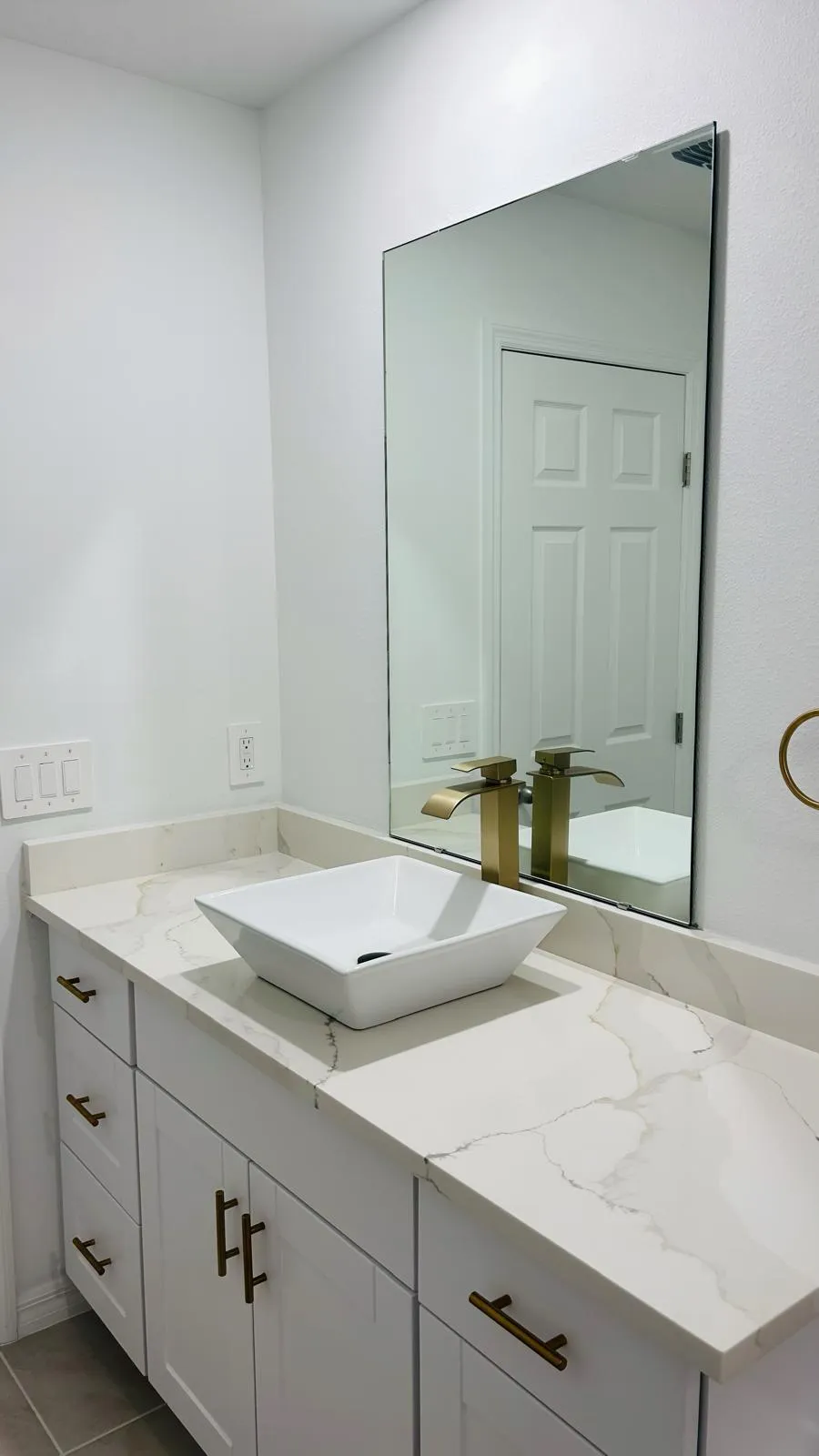 Double vanity with two vessel sinks and a wide mirror