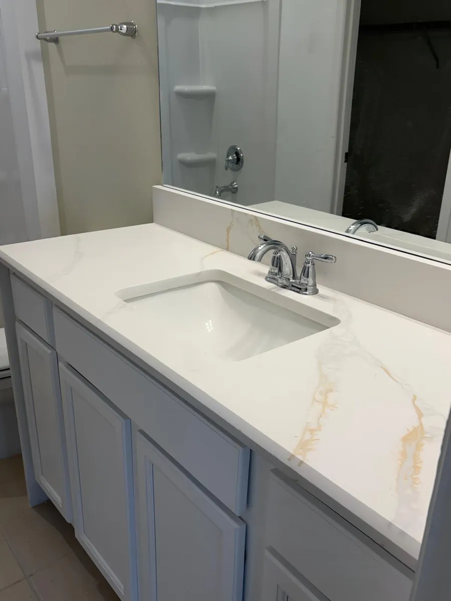 Single vanity top with an undermount sink and a light stone surface