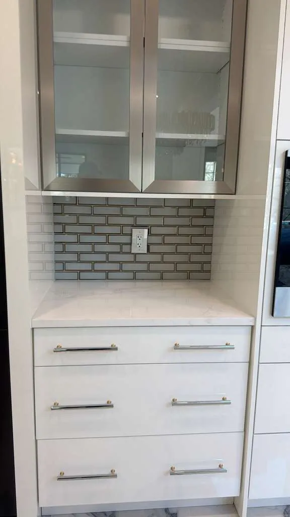 Tall cabinet run with glass upper doors and drawer bases