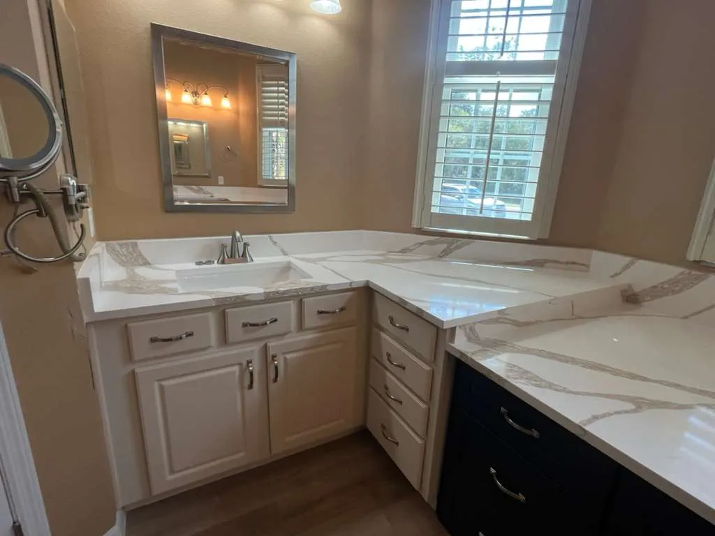 L shaped bathroom vanity top with a full height splash