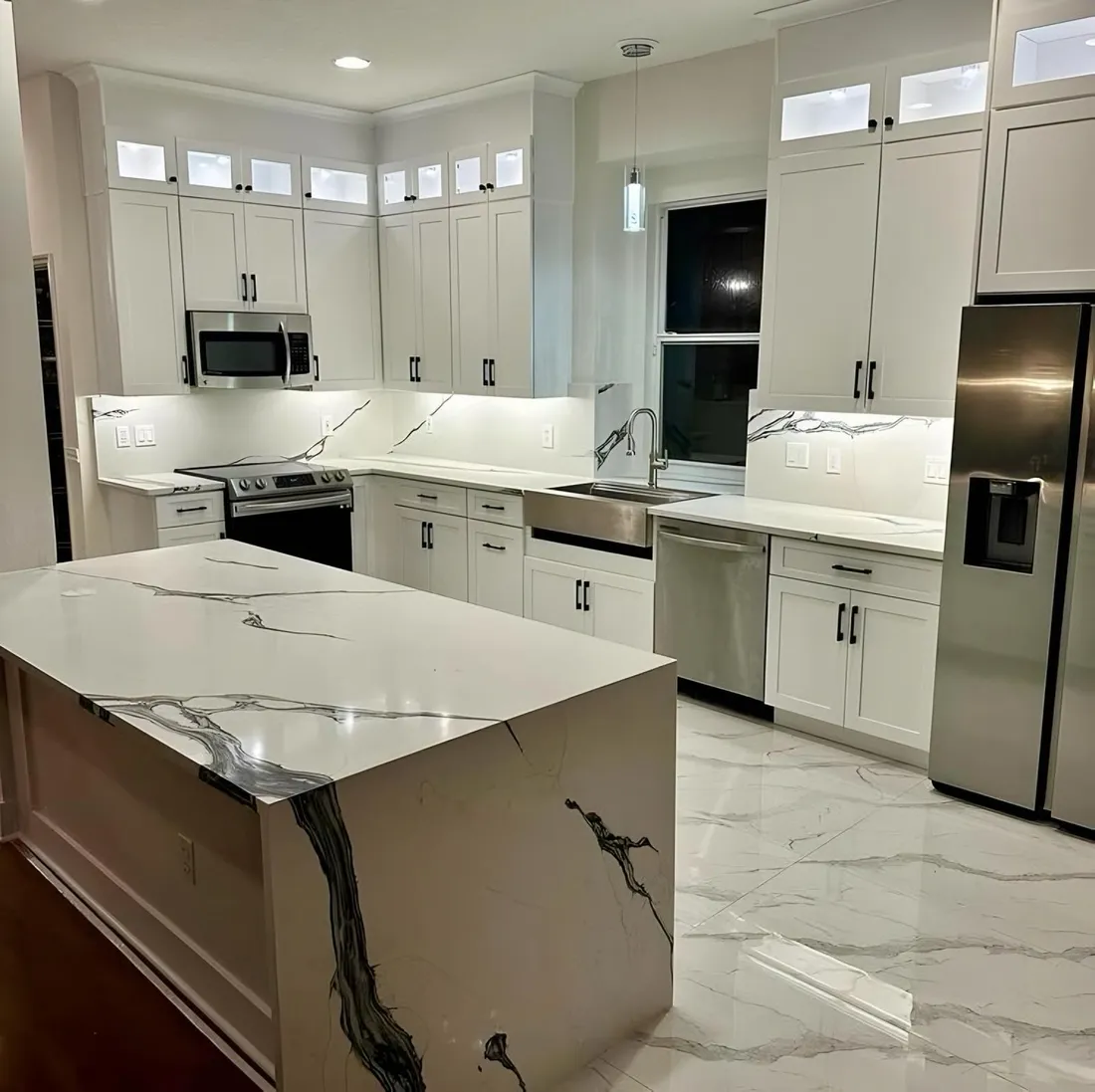 Kitchen island with a dark veined waterfall panel