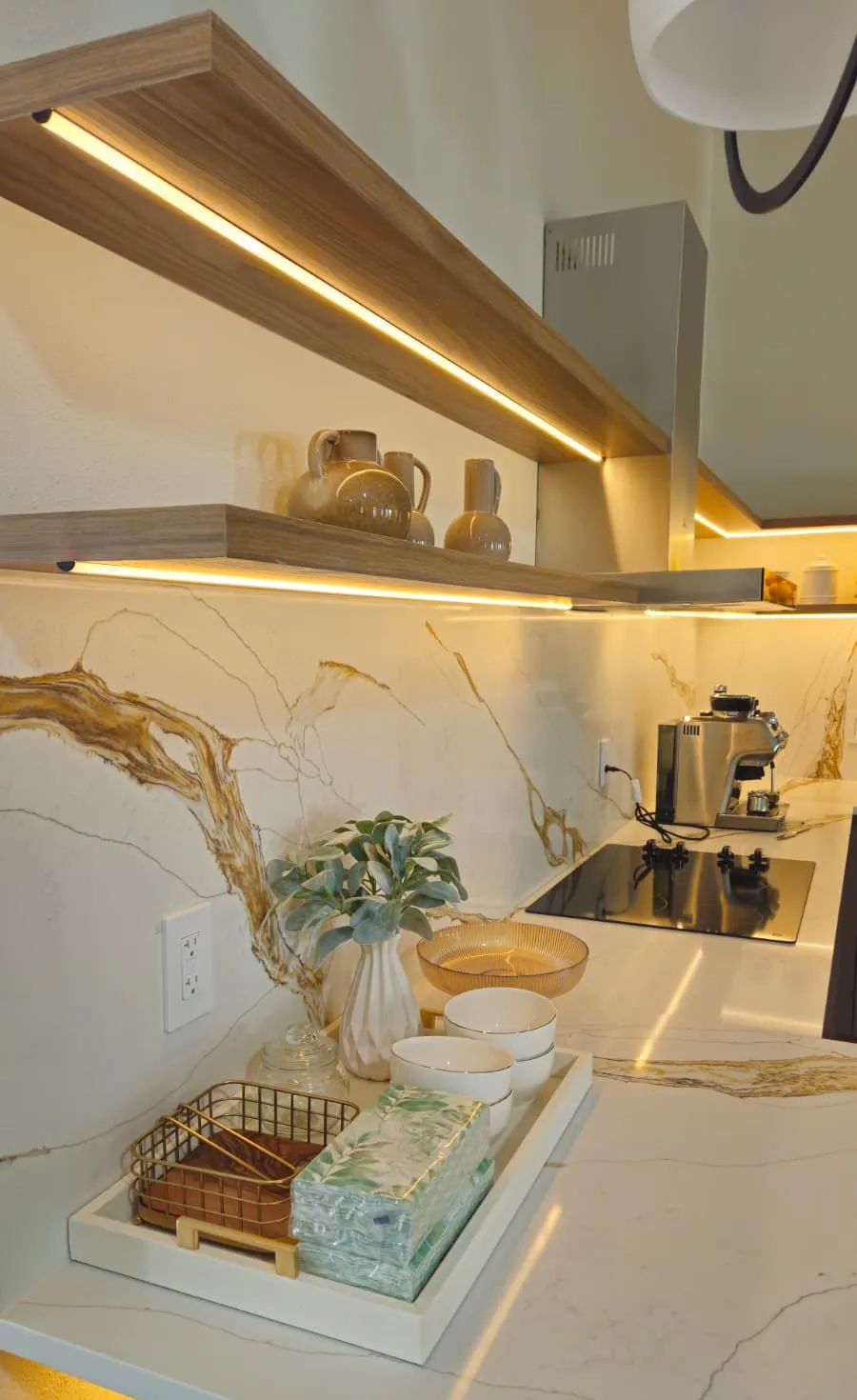Counter and full height splash in a light stone with gold veining