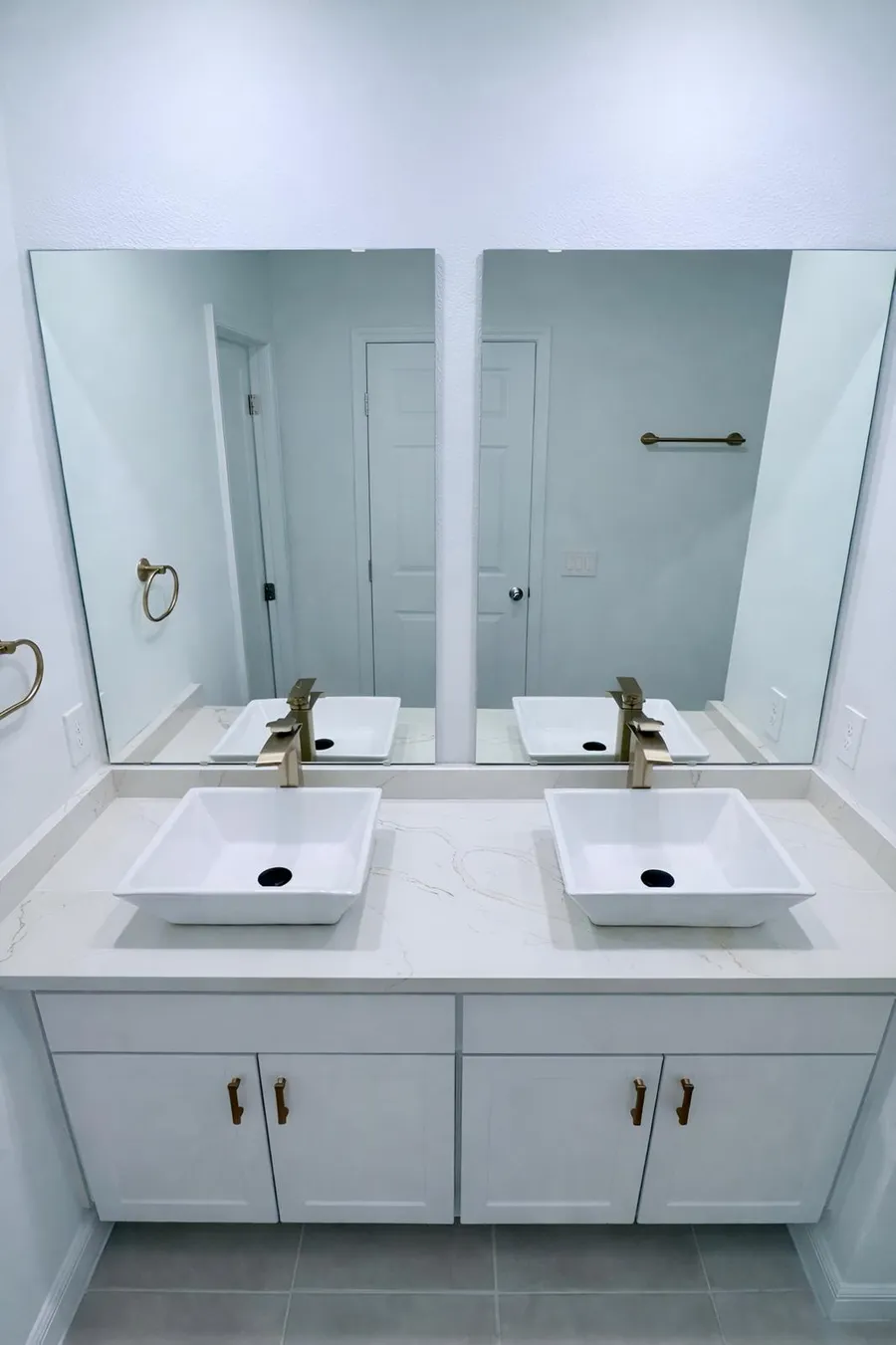 Double vanity top with two vessel sinks and gold fixtures